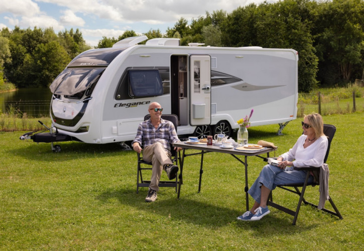 Couple sat outside Elegance Grande caravan