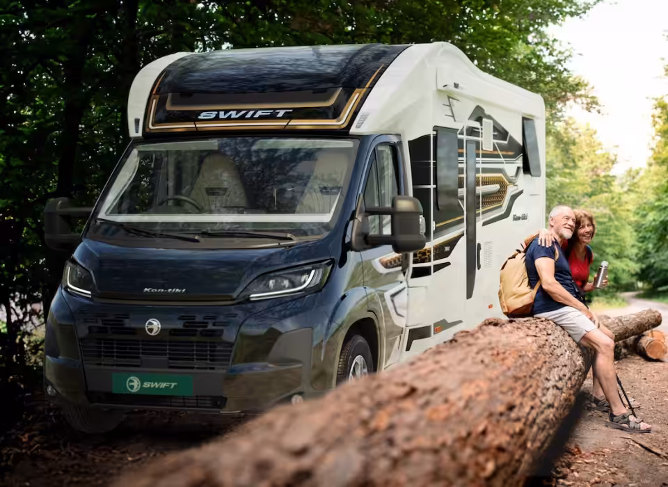Swift Kon Tiki motorhome with couple sat outside
