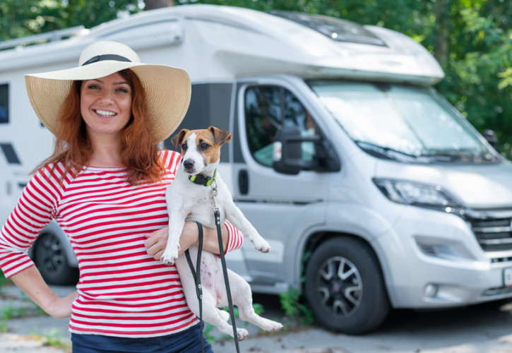 Woman Infront Of Motorhome With Dog